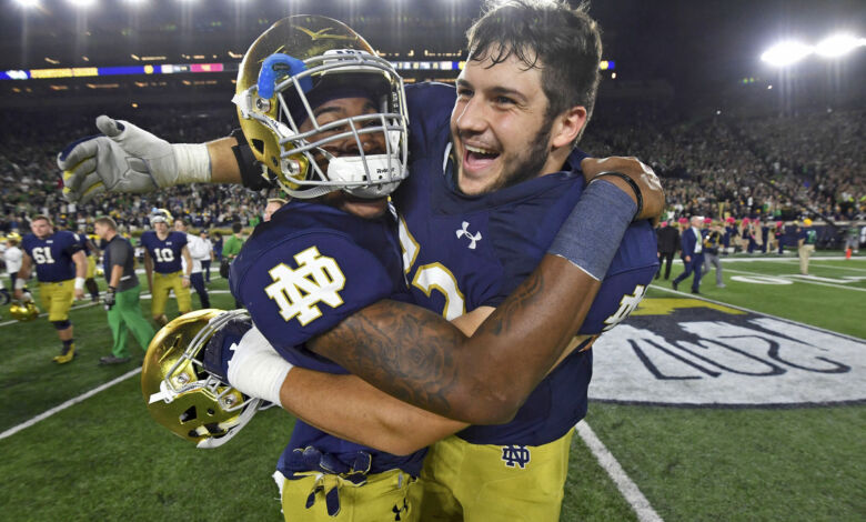 Notre Dame OL Robert Hainsey (right) celebrates with S Isaiah Robertson