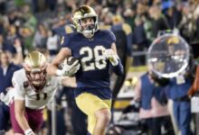 Notre Dame Fighting Irish safety Luke Talich (28) runs the ball for a touchdown